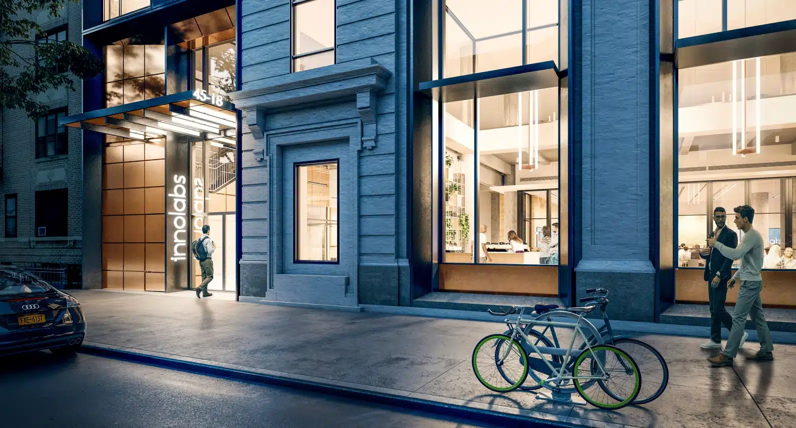 Evening exterior shot of Innolabs, with illuminated signage and glass-paneled entrance