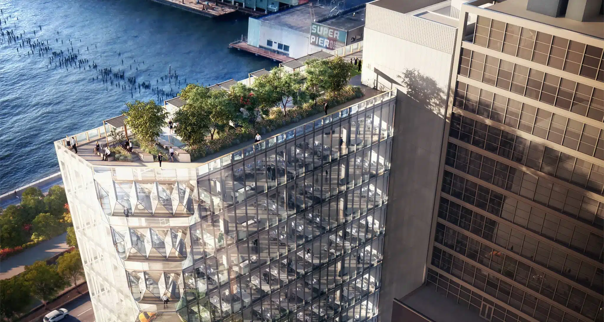 Modern glass office building with a rooftop garden overlooking a waterfront pier and cityscape