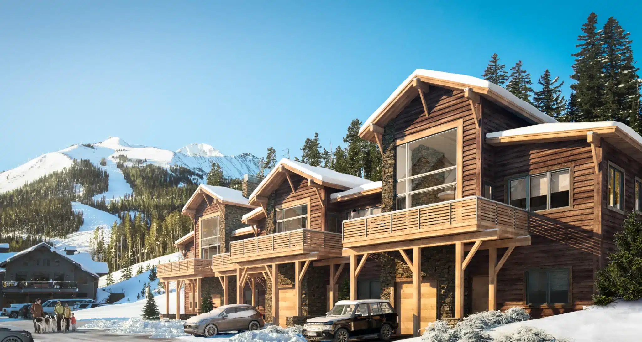 Luxury wooden mountain chalets with snow-covered roofs and scenic alpine slopes in the background