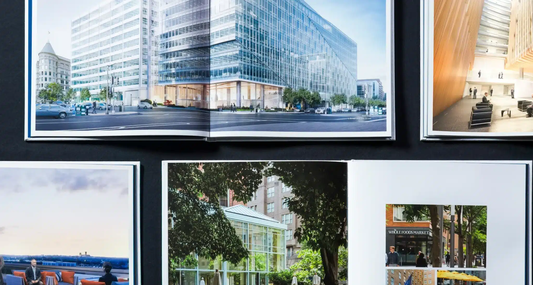 Open marketing book showcasing premium office developments with architectural photography