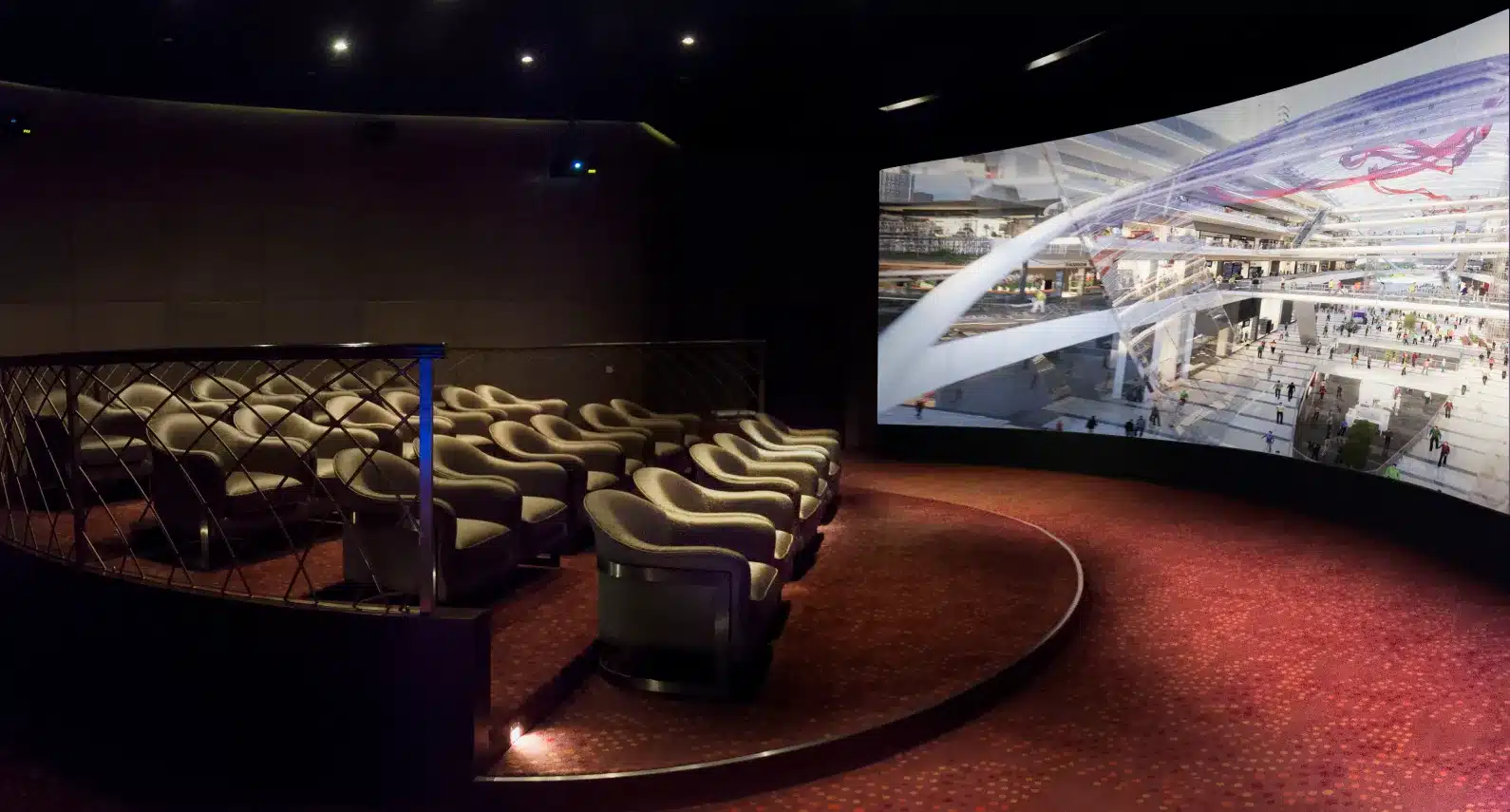 High-end screening room with curved display showcasing a futuristic commercial complex