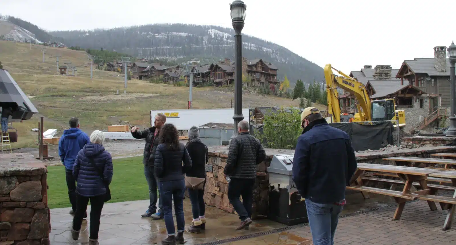 Real estate team touring a construction site near luxury mountain homes and ski resort amenities
