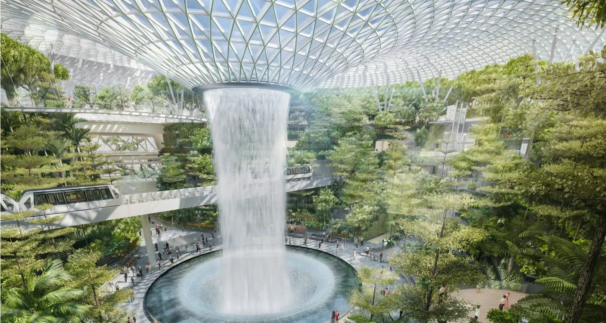 Indoor waterfall surrounded by lush vertical gardens beneath Jewel Changi’s glass-domed roof structure