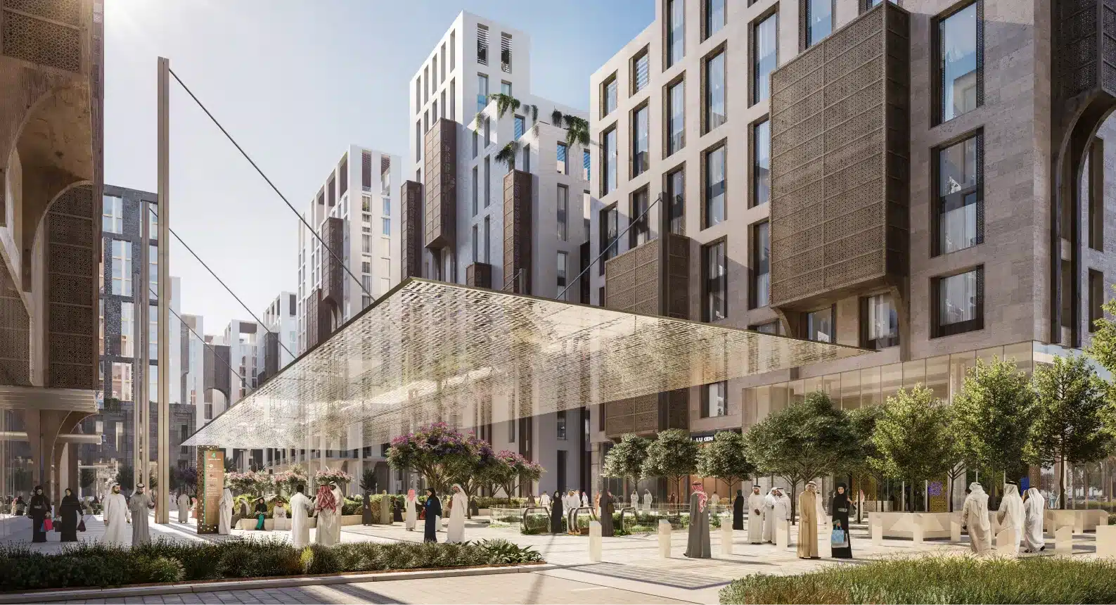 Community gathering space in Rua Al Madinah featuring wide walkways and lush greenery