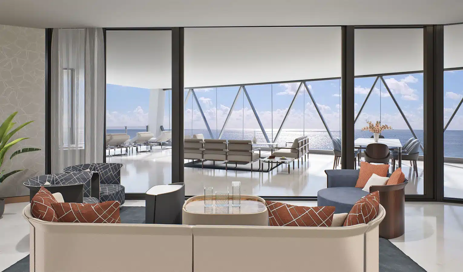 Open-concept living room with plush seating and panoramic ocean views through floor-to-ceiling glass