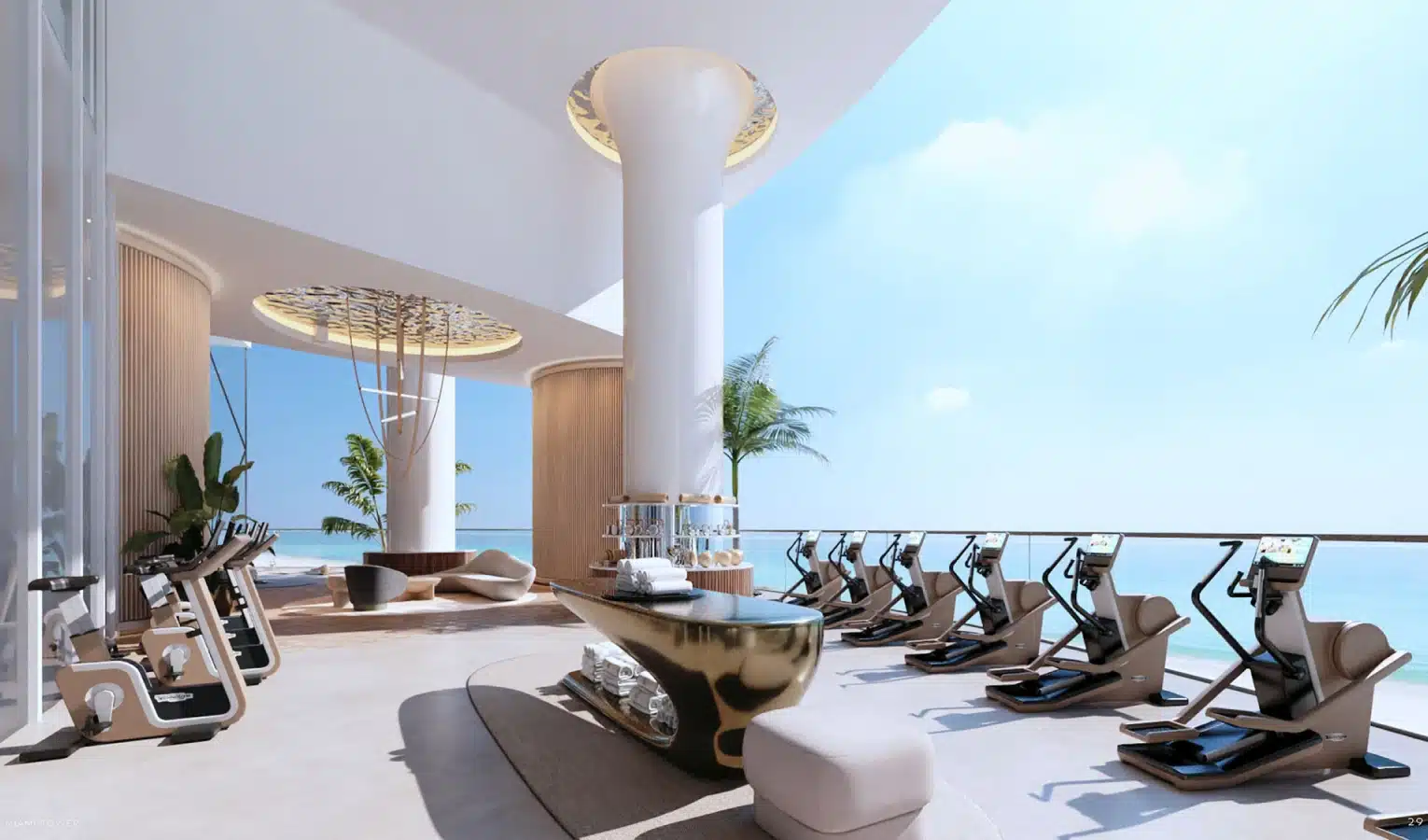 Open-air luxury gym with oceanfront views, modern equipment, and tropical palm trees