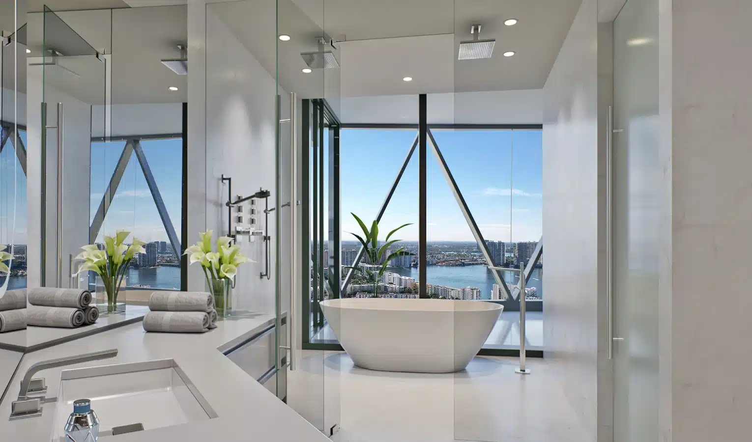 High-end bathroom with a freestanding tub, floor-to-ceiling windows, and city skyline views